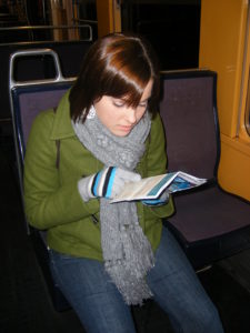 GIRL ON TRAIN LOOKING AT MAP