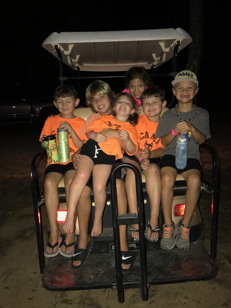 COUSINS SITTING TOGETHER ON GOLF CART-COUSIN CAMP