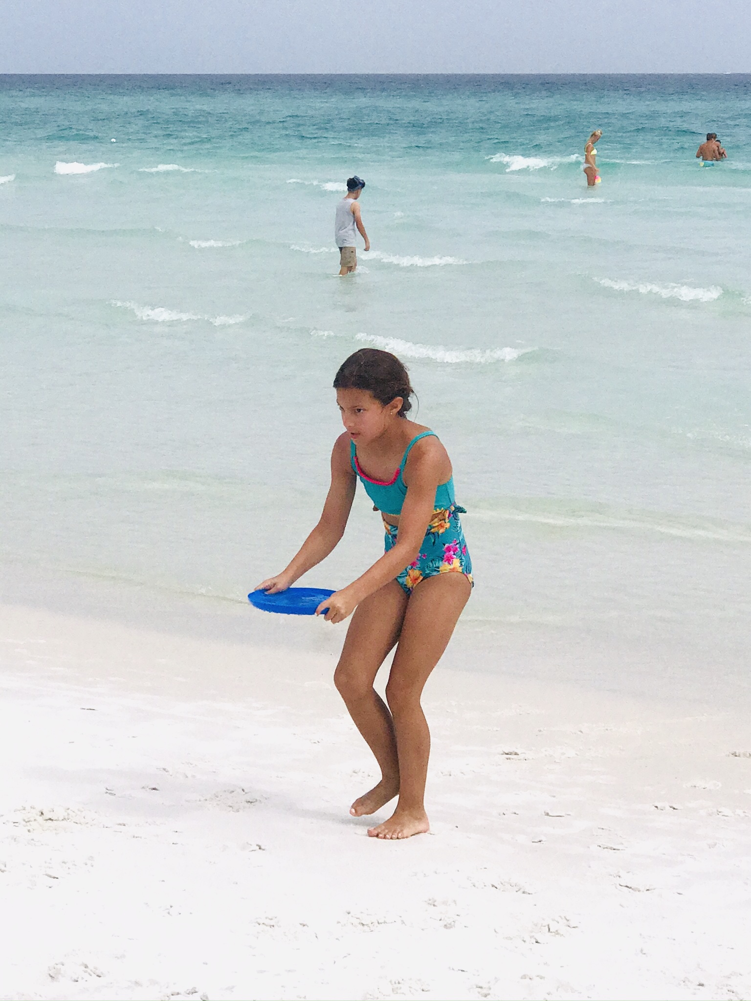 girl carrying frisbee full of water-family style cousin camp